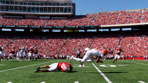 Oct 1, 2022; Madison, Wisconsin, USA; Illinois Fighting Illini wide receiver Isaiah Williams (1) is tackled by Wisconsin Badgers cornerback Justin Clark (21) during the second quarter at Camp Randall Stadium. Mandatory Credit: Jeff Hanisch-USA TODAY Sports